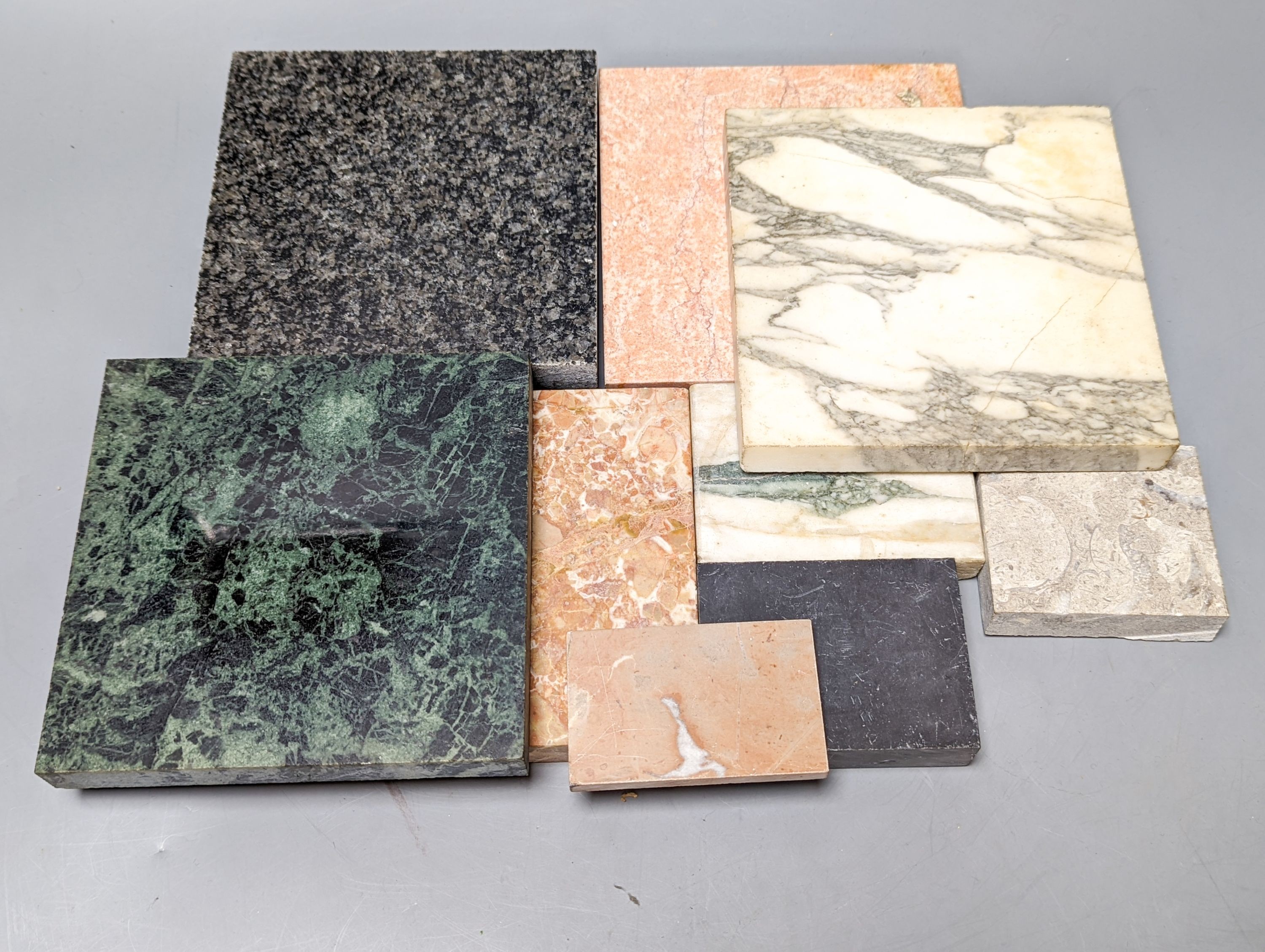 A group of cut stone samples, including marble and granite